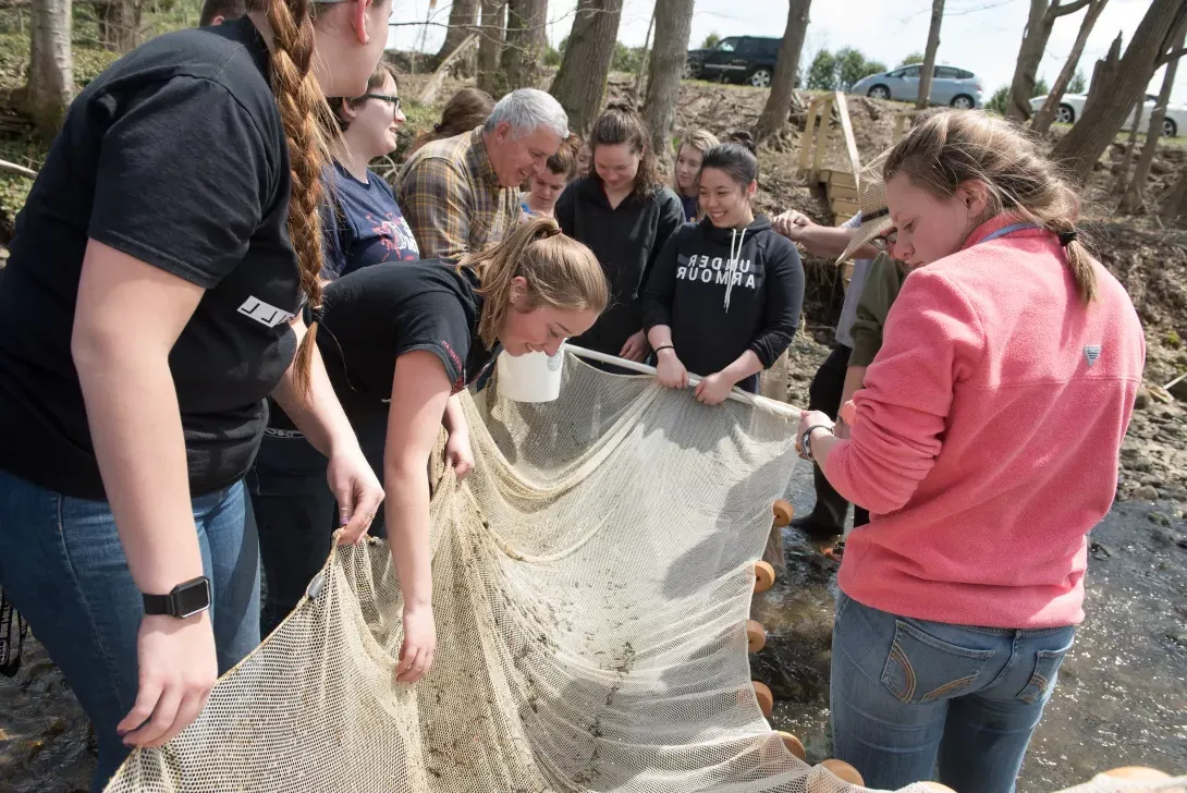 Students examine net after going through stream at Canfield Preserve