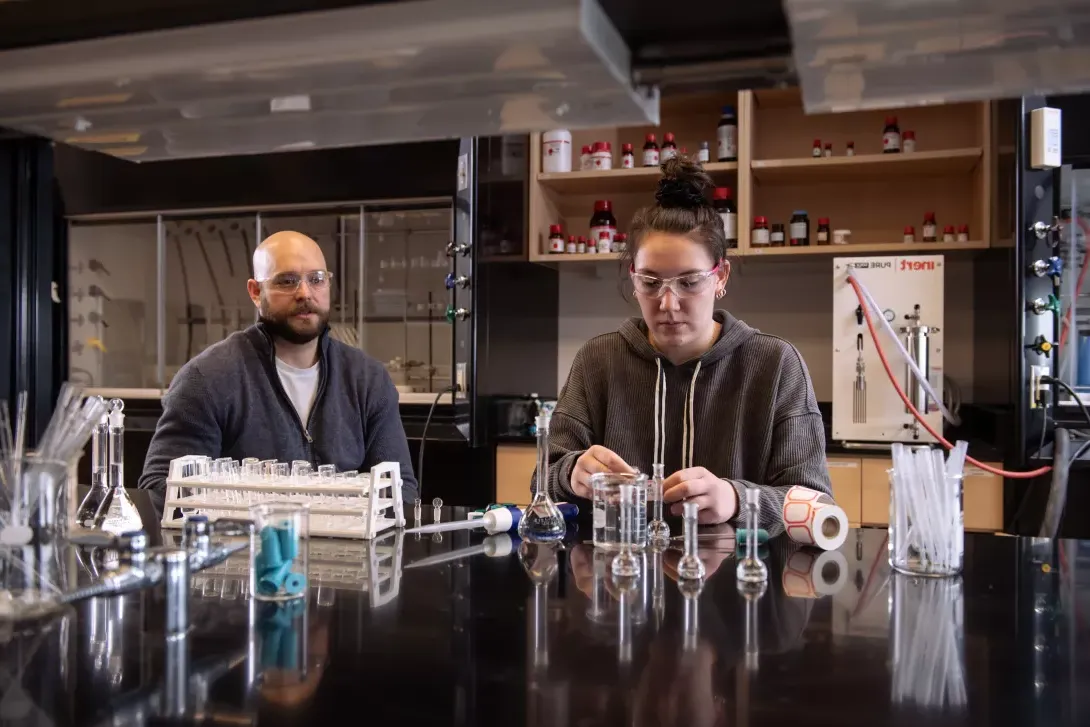 Chemistry professor oversees lab experiment by student